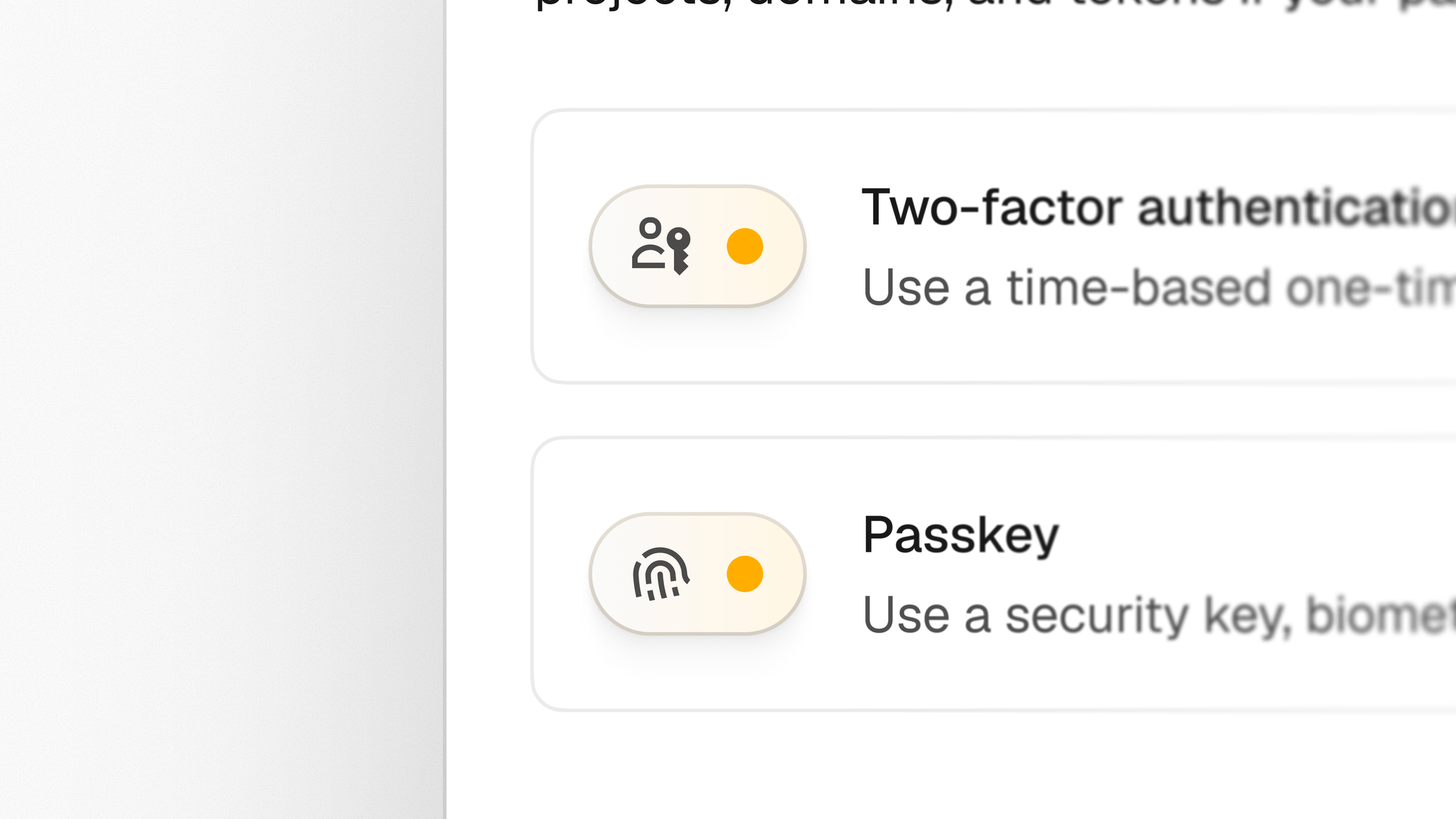 Close-up of the two-factor authentication and passkey row items with their yellow-accented icon pills